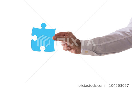 Isolated businessman holds a piace of puzzle. Concept teamwork, partnership, integration Isolated businessman holds a piace of puzzle. Concept teamwork, partnership, integration 104303037