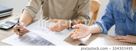 Concept of engineering consulting, Two female engineers discussing about blueprint of construction 104303495