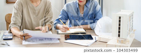 Engineering construction concept, Two female engineers is discussing construction and taking notes 104303499