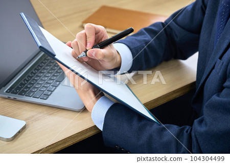穿著西裝的商人在辦公室回答調查問卷（部分剪切） 104304499