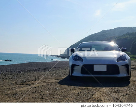 Sea, sandy beach and sports car 104304746