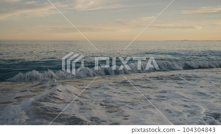 low angle shot of sunset on a pebble beach of Nice 104304843