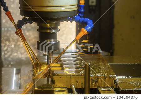The CNC milling machine cutting the mold base parts with oil coolant method . 104304876