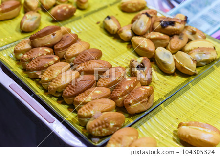 Vietnamese traditional corn cakes with chocolate sauce on a night market in food festival 104305324