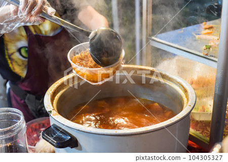 Vietnamese woman serving noodles soup with meat in vietnamese night market in food festival 104305327