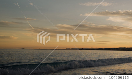 Low angle shot of sunset on a pebble beach of Nice 104306115