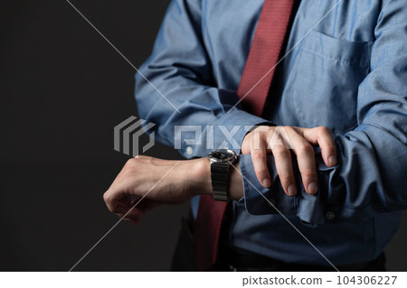 A businessman checking his watch A businessman checking his watch 104306227