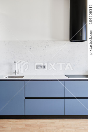 A modern kitchen with gleaming household equipment 104306513