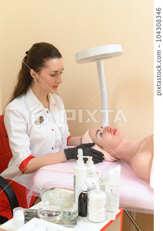 Portrait of a cosmetologist and a patient in the office 104308346