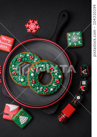 Beautiful bright colorful homemade gingerbread cookies on a ceramic plate Beautiful bright colorful homemade gingerbread cookies on a ceramic plate 104310194