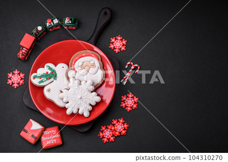 Beautiful bright colorful homemade gingerbread cookies on a ceramic plate 104310270