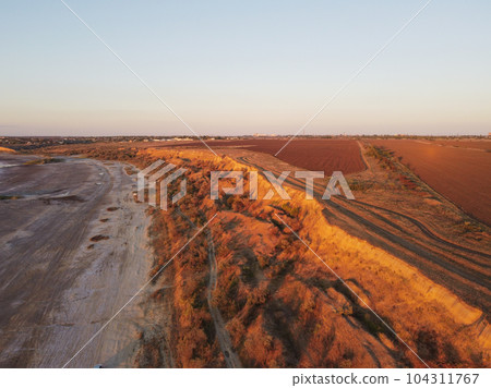Dramatic towers and red sandstone cliffs cast purple shadows at sunset in Odessa Dramatic towers and red sandstone cliffs cast purple shadows at sunset in Odessa 104311767