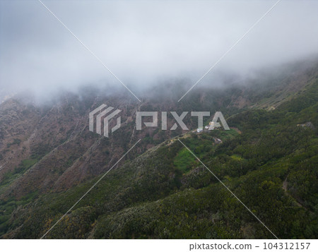 fog with wind and misty cloud in green mountains, Anaga park, Tenerife, Canary 104312157