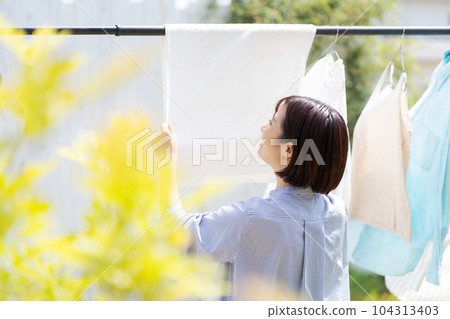 Photo of a woman doing laundry Photo of a woman doing laundry 104313403
