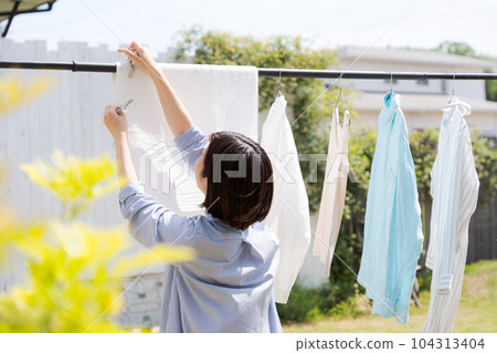 Photo of a woman doing laundry 104313404