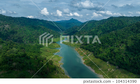 Aerial view tropical green forest and river with mountains in background, Green tree forest view from above river and forest. 104314390