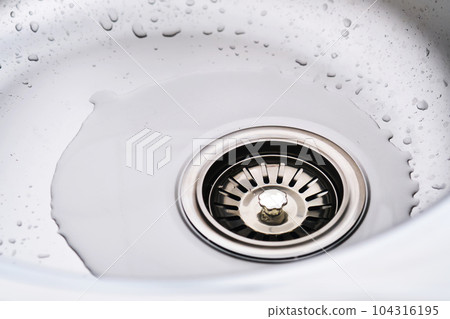 Stainless steel sink with splash of water. Stainless steel sink with splash of water. 104316195