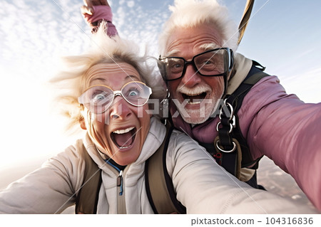 Selfie skydiving tandem of an elderly couple Selfie skydiving tandem of an elderly couple 104316836