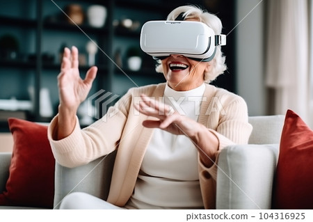 Senior mature female having fun with virtual reality glasses. Old woman using new headset goggles trends technology Senior mature female having fun with virtual reality glasses. Old woman using new headset goggles trends technology 104316925
