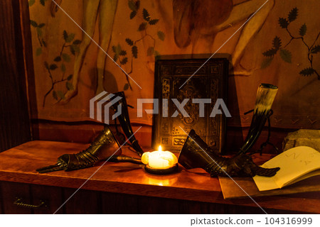 low key image of beautiful queen or king hand armor in front of old book fantasy medieval period low key image of beautiful queen or king hand armor in front of old book fantasy medieval period 104316999