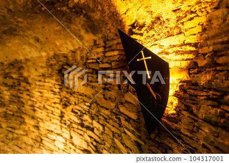 Old light at night hanging on a medieval fortress wall background torch stand or mount Old light at night hanging on a medieval fortress wall background torch stand or mount 104317001