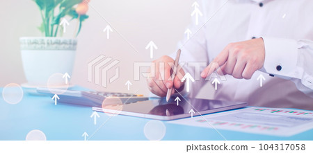 Businessman drawing a graph of growth and progress. Investment technology, finance, payback Businessman drawing a graph of growth and progress. Investment technology, finance, payback 104317058