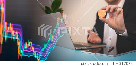 Laptop with chart and bitcoin in hands. Cryptocurrency gold coin, stock exchange graph background. 104317072