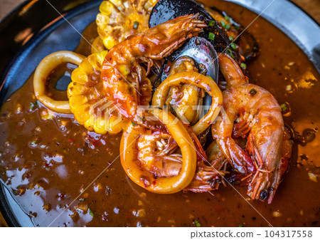 delicious spicy mixed seafood - shrimps, sqiud, mussel and corn delicious spicy mixed seafood - shrimps, sqiud, mussel and corn 104317558