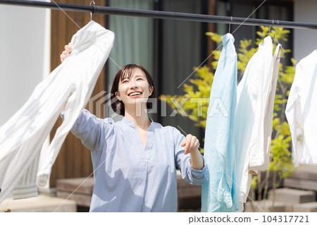 Portrait of a woman doing laundry Portrait of a woman doing laundry 104317721