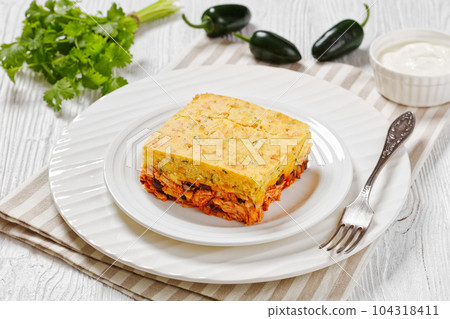 Chicken Tamale Pie on white plate, top view Chicken Tamale Pie on white plate, top view 104318411