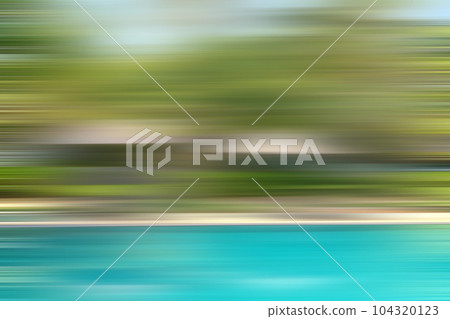 Bright turquoise lake on a background of greenery in a blur of motion 104320123