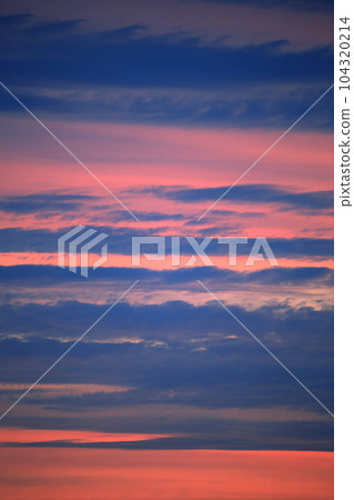 The morning sky with a beautiful gradation of orange and clouds The morning sky with a beautiful gradation of orange and clouds 104320214