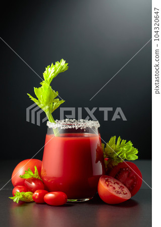 Fresh tomato juice or cocktail Bloody Mary with celery. 104320647