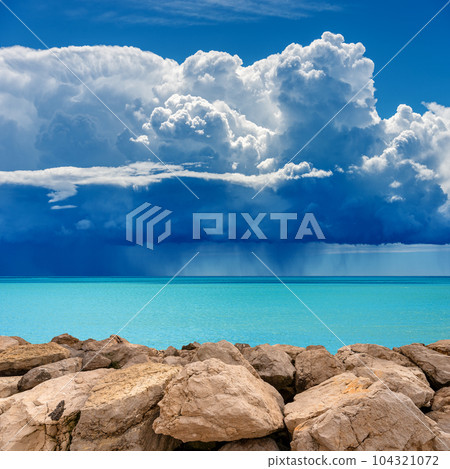 Breakwater and Seascape with Storm Clouds and Torrential Rain 104321072