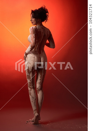 Naked woman with plaster covering body in studio Naked woman with plaster covering body in studio 104321714