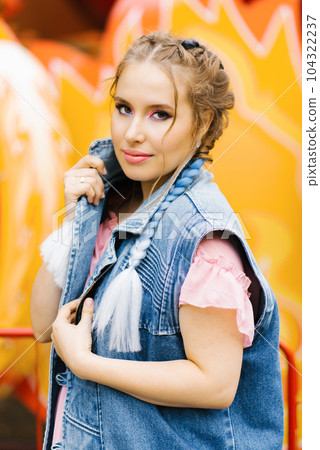 Portrait of a stylish young woman with blue pigtails and bright makeup 104322237