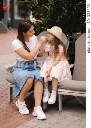 Mom and daughter have fun during they eating ice cream. Rest after shopping  104322490