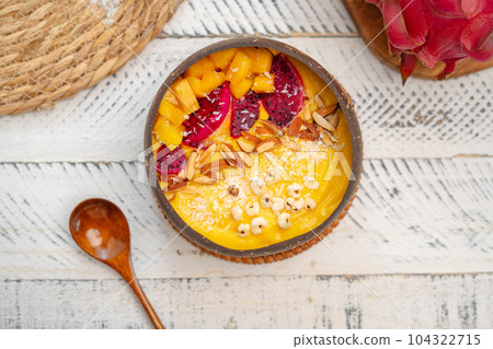 Mango Fruit Smoothie Bowl in Coconut Shell Cup Mango Fruit Smoothie Bowl in Coconut Shell Cup 104322715