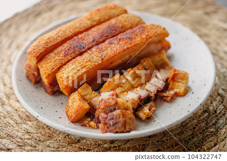 crispy fried pork belly in a plate 104322747