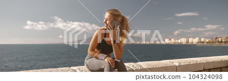 Young attractive female breathing fresh air outdoors 104324098