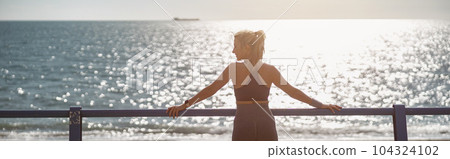 Fit young woman resting at beautiful coastline 104324102