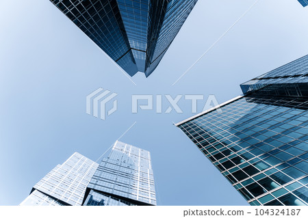 Business skyscrapers and office business center building architecture in perspective on blue sky. Economy, exchange, finance concept. Business skyscrapers and office business center building architecture in perspective on blue sky. Economy, exchange, finance concept. 104324187