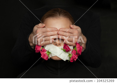 Domestic violence and harassment concept. Woman with closed mouth and male hands on her eyes Domestic violence and harassment concept. Woman with closed mouth and male hands on her eyes 104325269