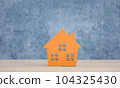 orange wood home model on blue background 104325430