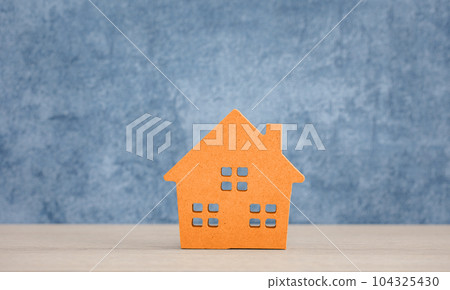orange wood home model on blue background 104325430