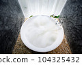 circle bathtub full with bath foam in bathroom 104325432