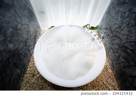 circle bathtub full with bath foam in bathroom circle bathtub full with bath foam in bathroom 104325432