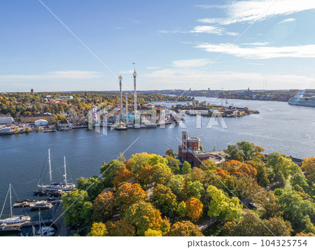 View of amusement park Grona Lund with carousels and tour rides on Djurgarden island Stockholm Sweden View of amusement park Grona Lund with carousels and tour rides on Djurgarden island Stockholm Sweden 104325754