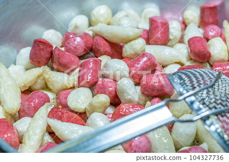 Deep fried meatballs and sausage in the pan, Popular Thai street food. 104327736