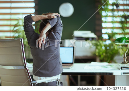 modern business woman in modern green office stretching hand 104327838